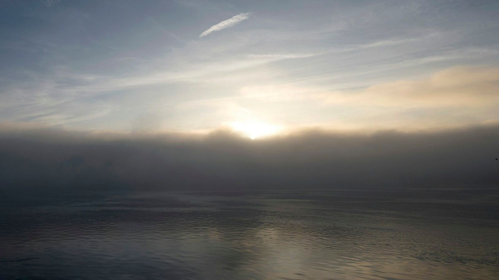 Sunrise over calm water