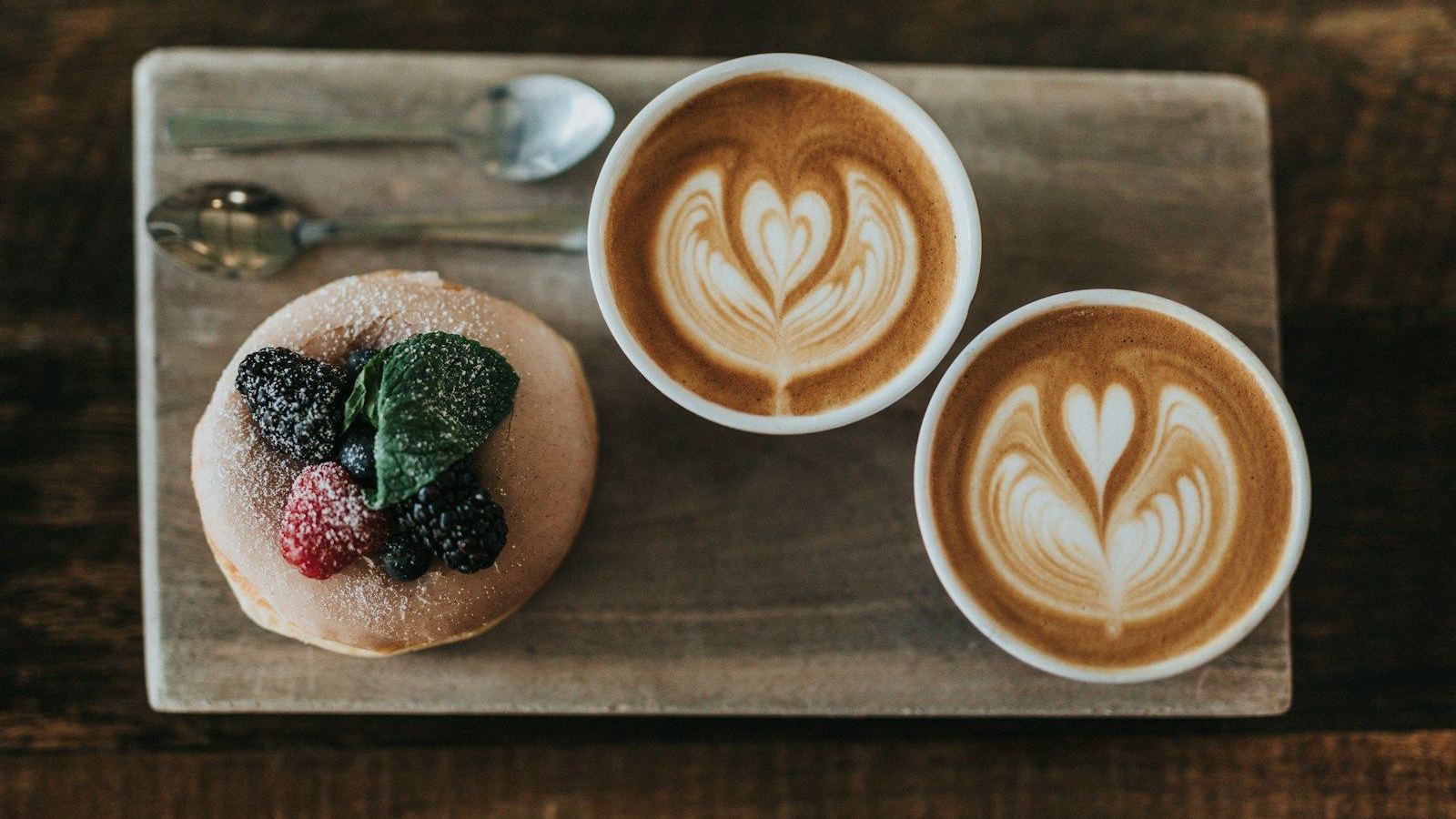 Two white mugs on wooden boards
